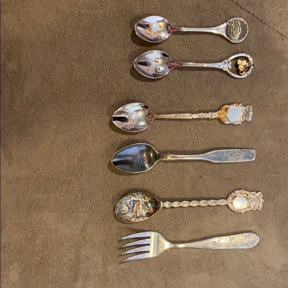 5 small decorative spoons and one fork.